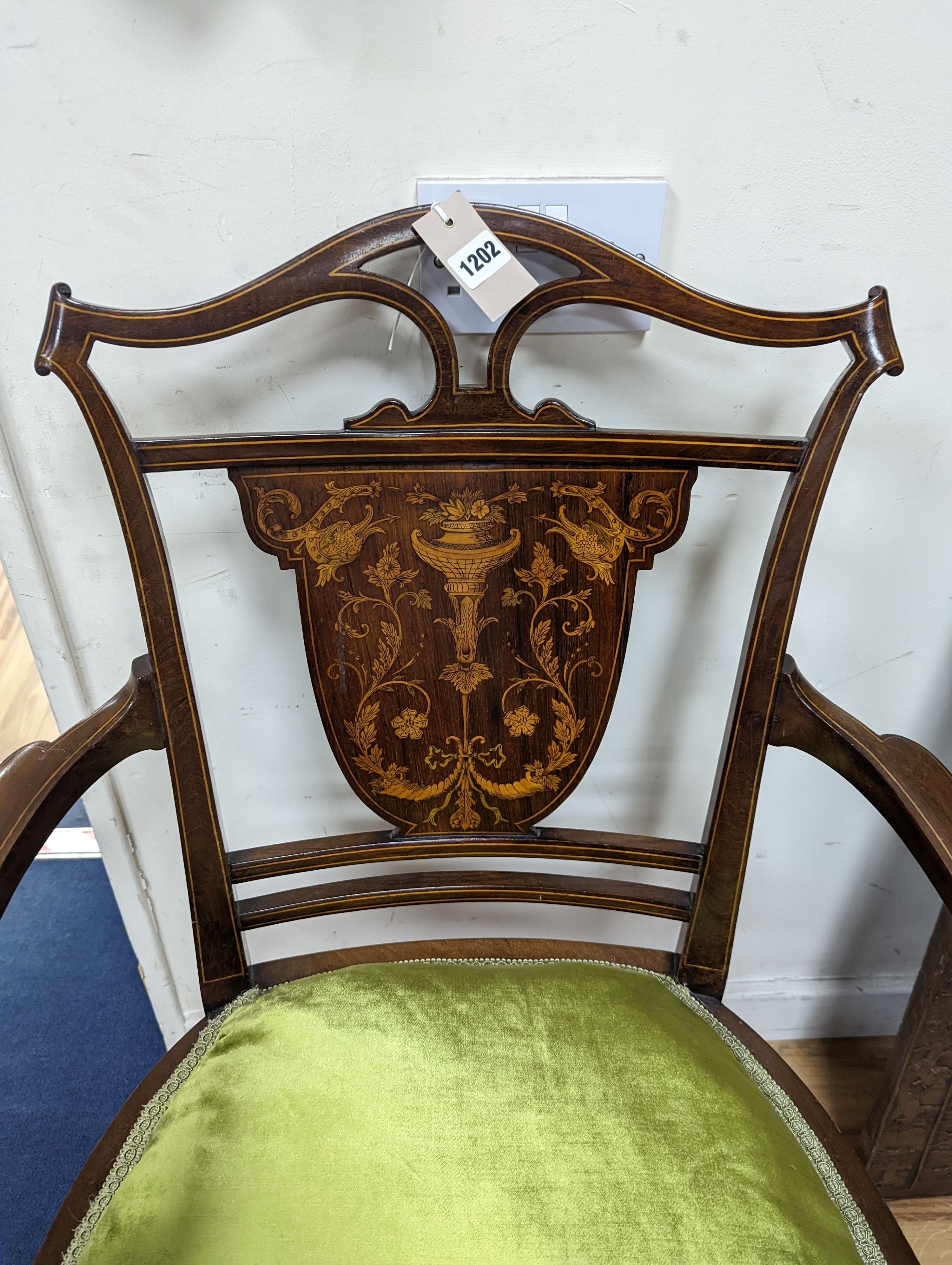 An Edwardian marquetry inlaid mahogany elbow chair